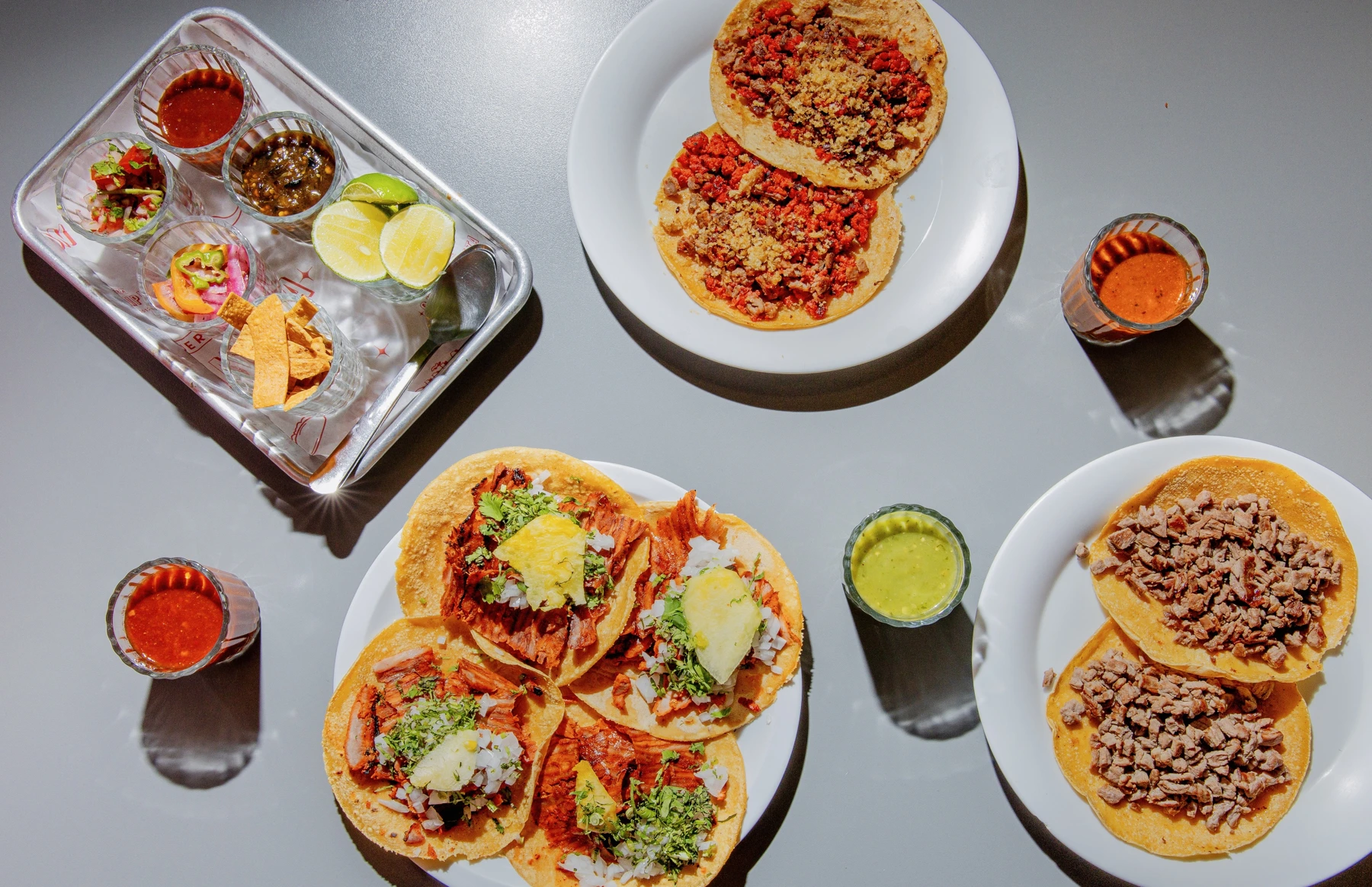 Mesa de Chinampita con tacos de pastor, bistec, chorizo y salsas